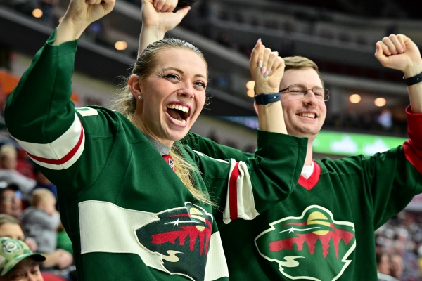 Two Iowa Wild fans cheering at an Iowa Wild game.